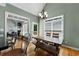 Dining room with hardwood floors, chandelier, and natural light, next to a living room at 1377 Downington Nw Ln, Acworth, GA 30101