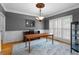 Elegant dining room featuring wainscoting, chandelier, hardwood floors, and large windows at 1377 Downington Nw Ln, Acworth, GA 30101