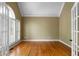 Bright, empty room with hardwood floors, white trim, and french doors, perfect for customization at 1377 Downington Nw Ln, Acworth, GA 30101