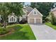 Charming traditional home with lush front yard, manicured landscaping, and two-car garage at 1377 Downington Nw Ln, Acworth, GA 30101