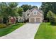 Charming two-story home with a manicured lawn, two-car garage, and inviting curb appeal at 1377 Downington Nw Ln, Acworth, GA 30101