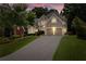 Charming two-story home with a manicured lawn, two-car garage, and inviting curb appeal at sunset at 1377 Downington Nw Ln, Acworth, GA 30101