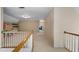 Upstairs hallway with carpeted floors, white railing, and access to multiple rooms at 1377 Downington Nw Ln, Acworth, GA 30101