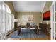 Bright office with french doors, large desk with laptop, and built-in shelving at 1377 Downington Nw Ln, Acworth, GA 30101