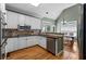 Modern kitchen features white cabinets, stainless steel appliances, granite countertops, and hardwood floors at 1377 Downington Nw Ln, Acworth, GA 30101