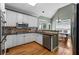 Cozy kitchen with white cabinets, stainless appliances, granite counters, and hardwood floors at 1377 Downington Nw Ln, Acworth, GA 30101