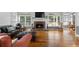 Inviting living room featuring a fireplace, hardwood floors, and large windows offering backyard views at 1377 Downington Nw Ln, Acworth, GA 30101