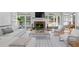 Sunlit living room boasts fireplace, hardwood floors, and comfortable seating arrangements at 1377 Downington Nw Ln, Acworth, GA 30101