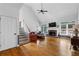Open living room with fireplace, hardwood floors, vaulted ceilings, and ample natural light at 1377 Downington Nw Ln, Acworth, GA 30101