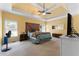 Spacious main bedroom featuring a tray ceiling, ceiling fan, and a wooden headboard at 1377 Downington Nw Ln, Acworth, GA 30101