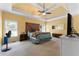Spacious main bedroom with tray ceiling, ceiling fan, and large bed at 1377 Downington Nw Ln, Acworth, GA 30101