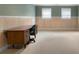 Spacious room with carpet flooring, wood-paneled walls, and natural light from windows, ideal for an office at 1377 Downington Nw Ln, Acworth, GA 30101