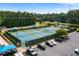 Full view of community tennis courts, playground, and parking lot surrounded by lush trees at 1377 Downington Nw Ln, Acworth, GA 30101
