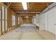 Unfinished basement with exposed wooden beams, concrete floor, and visible utility connections at 1750 Providence Place Dr, Alpharetta, GA 30009