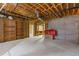 Spacious unfinished basement with concrete floors, exposed ceiling, and a shelving unit at 1750 Providence Place Dr, Alpharetta, GA 30009
