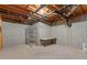 Unfinished basement with concrete walls, open ceiling with pipes, and metal shelving unit at 1750 Providence Place Dr, Alpharetta, GA 30009
