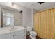 Bathroom with white sink and cabinet, toilet and shower with patterned curtain at 1750 Providence Place Dr, Alpharetta, GA 30009