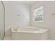 Bright bathroom featuring a modern bathtub, a shower, and natural light from the window at 1750 Providence Place Dr, Alpharetta, GA 30009