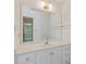Bright bathroom with white vanity, countertop, and framed mirror with view into the bedroom at 1750 Providence Place Dr, Alpharetta, GA 30009