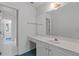 Bright bathroom with white vanity, countertop, and framed mirror with view into the hallway at 1750 Providence Place Dr, Alpharetta, GA 30009
