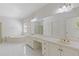 Bright bathroom features a large vanity with dual sinks, a soaking tub, and white tile floors at 1750 Providence Place Dr, Alpharetta, GA 30009