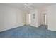 Bright bedroom with blue carpet, ceiling fan, white walls, and doorways to other rooms at 1750 Providence Place Dr, Alpharetta, GA 30009