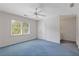 Spacious bedroom with large window, ceiling fan, blue carpet and adjoining bathroom at 1750 Providence Place Dr, Alpharetta, GA 30009
