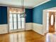 Dining room featuring chair rail, hardwood floors, and elegant lighting at 1750 Providence Place Dr, Alpharetta, GA 30009