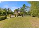 Lovely lawn with flowering bushes and a brick home on a sunny day at 1750 Providence Place Dr, Alpharetta, GA 30009