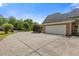Spacious garage with a long concrete driveway and mature trees at 1750 Providence Place Dr, Alpharetta, GA 30009
