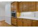This kitchen features natural wood cabinets, hardwood floors, stainless steel appliances, and floral tile backsplash at 1750 Providence Place Dr, Alpharetta, GA 30009