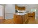 This kitchen features natural wood cabinets, hardwood floors, stainless steel appliances, and center island at 1750 Providence Place Dr, Alpharetta, GA 30009