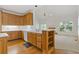 This kitchen features natural wood cabinets, hardwood floors, and a center island with countertop seating at 1750 Providence Place Dr, Alpharetta, GA 30009