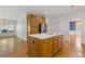 This kitchen features natural wood cabinets, hardwood floors, stainless steel refrigerator, and center island at 1750 Providence Place Dr, Alpharetta, GA 30009