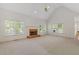 Inviting living room featuring a fireplace, large windows, and neutral carpet with high ceilings at 1750 Providence Place Dr, Alpharetta, GA 30009