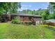 Brick home featuring backyard patio, steps, and green landscaping at 2714 Laurel Ridge Dr, Decatur, GA 30033