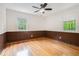 Bedroom with paneled walls, hardwood floors, ceiling fan, and natural light at 2714 Laurel Ridge Dr, Decatur, GA 30033