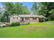 Charming single-story home featuring a brick facade, manicured lawn, and a convenient carport at 2714 Laurel Ridge Dr, Decatur, GA 30033