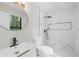 Bathroom featuring marble tile, updated fixtures, and a glass shower at 5401 Martins Crossing Rd, Stone Mountain, GA 30088