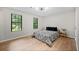 Bedroom featuring hardwood floors, 2 windows, and a comfy bed at 5401 Martins Crossing Rd, Stone Mountain, GA 30088
