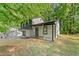 Inviting exterior showcasing stone details, a covered front porch, and natural surroundings at 5401 Martins Crossing Rd, Stone Mountain, GA 30088