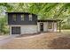 Charming split-level home featuring stone accents, a covered porch, and an attached garage at 5401 Martins Crossing Rd, Stone Mountain, GA 30088