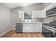 Modern kitchen with white cabinets, stainless appliances and a view to the backyard at 5401 Martins Crossing Rd, Stone Mountain, GA 30088