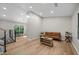 Bright living room with wood floors, neutral walls, and modern furnishings at 5401 Martins Crossing Rd, Stone Mountain, GA 30088