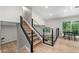 Stylish living area with hardwood floors, a staircase with metal railings, and lots of space at 5401 Martins Crossing Rd, Stone Mountain, GA 30088