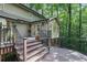 Large back deck featuring stairs, black metal railings, and access to the home at 960 Lost Forest Dr, Sandy Springs, GA 30328