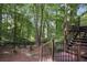Cozy backyard with a wooden staircase leading up to the deck at 960 Lost Forest Dr, Sandy Springs, GA 30328