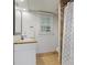 Bathroom with single sink vanity, tile flooring, and shower with patterned curtain at 960 Lost Forest Dr, Sandy Springs, GA 30328