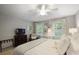 Bright bedroom with white ceiling fan, desk, and plenty of natural light at 960 Lost Forest Dr, Sandy Springs, GA 30328