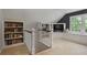 Upper hall bonus room includes media built-ins, window seating and a staircase at 960 Lost Forest Dr, Sandy Springs, GA 30328